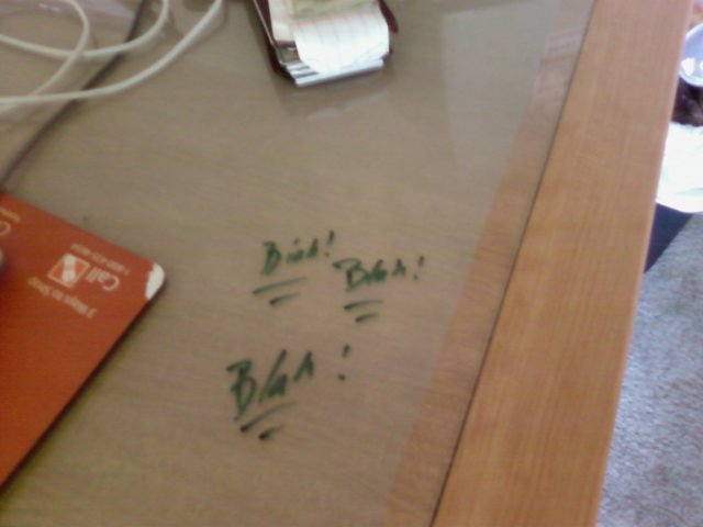 Chad took some notes on his desk with the dry erase while on the phone with a client             